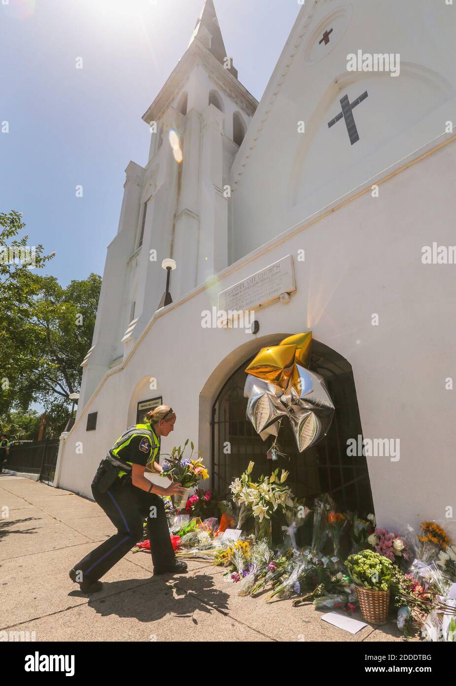 NO FILM, NO VIDEO, NO TV, NO DOCUMENTARY - Charleston City Police Officer T. Graves transfers flowers that were left on the corner of Calhoun Street to the front of Emanuel AME Church on June 18, 2015, where nine people were shot to death in Charleston, SC, USA. Photo by Tim Dominick/The State/TNS/ABACAPRESS.COM Stock Photo