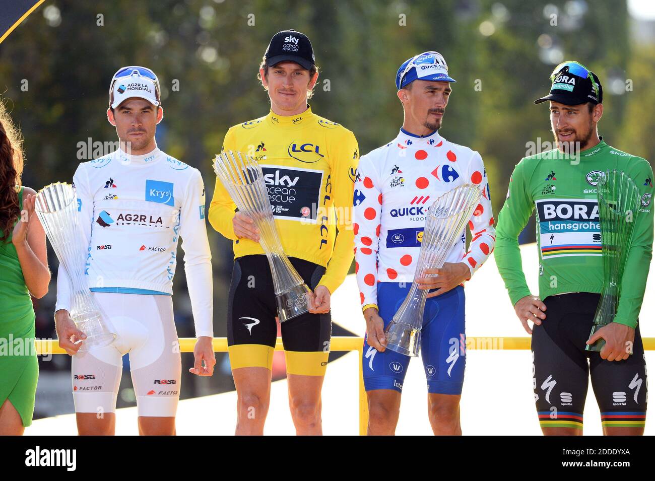 French Pierre Latour of AG2R La Mondiale wearing the white jersey for the  best young rider, British Geraint Thomas of Team Sky wearing the yellow  jersey of overall leader, French Julian Alaphilippe