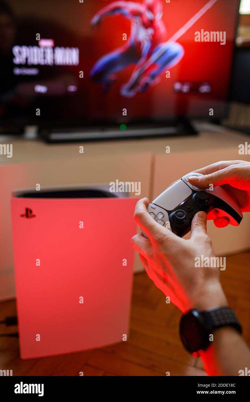 PlayStation 5 Sony reveals PS5 console and games. Dualsense controller.  Spider-Man: Miles Morales is PS5's biggest launch game. Man holding  joystick Stock Photo - Alamy