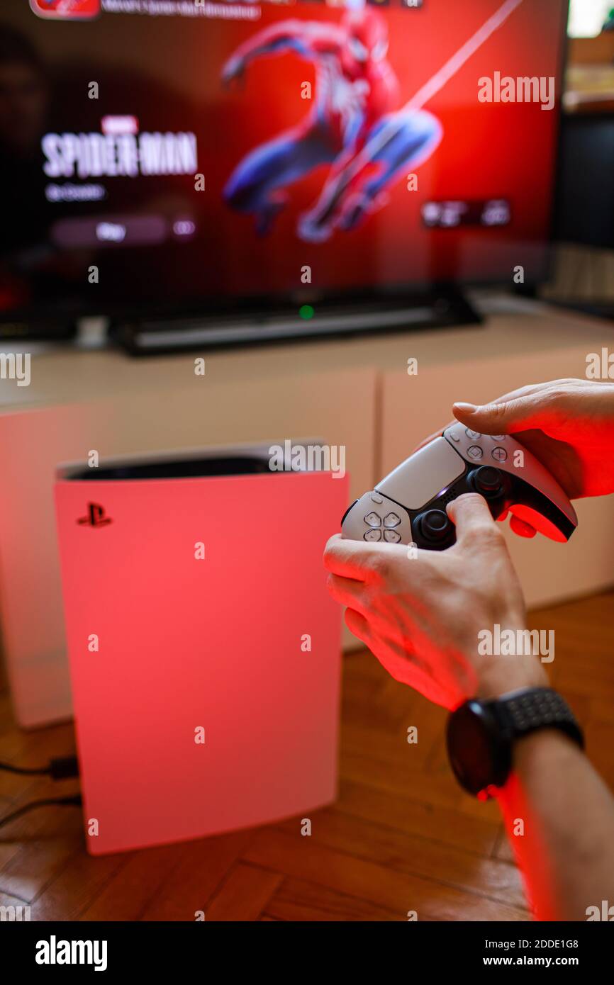 PlayStation 5 Sony reveals PS5 console and games. Dualsense controller.  Spider-Man: Miles Morales is PS5's biggest launch game. Man holding  joystick Stock Photo - Alamy