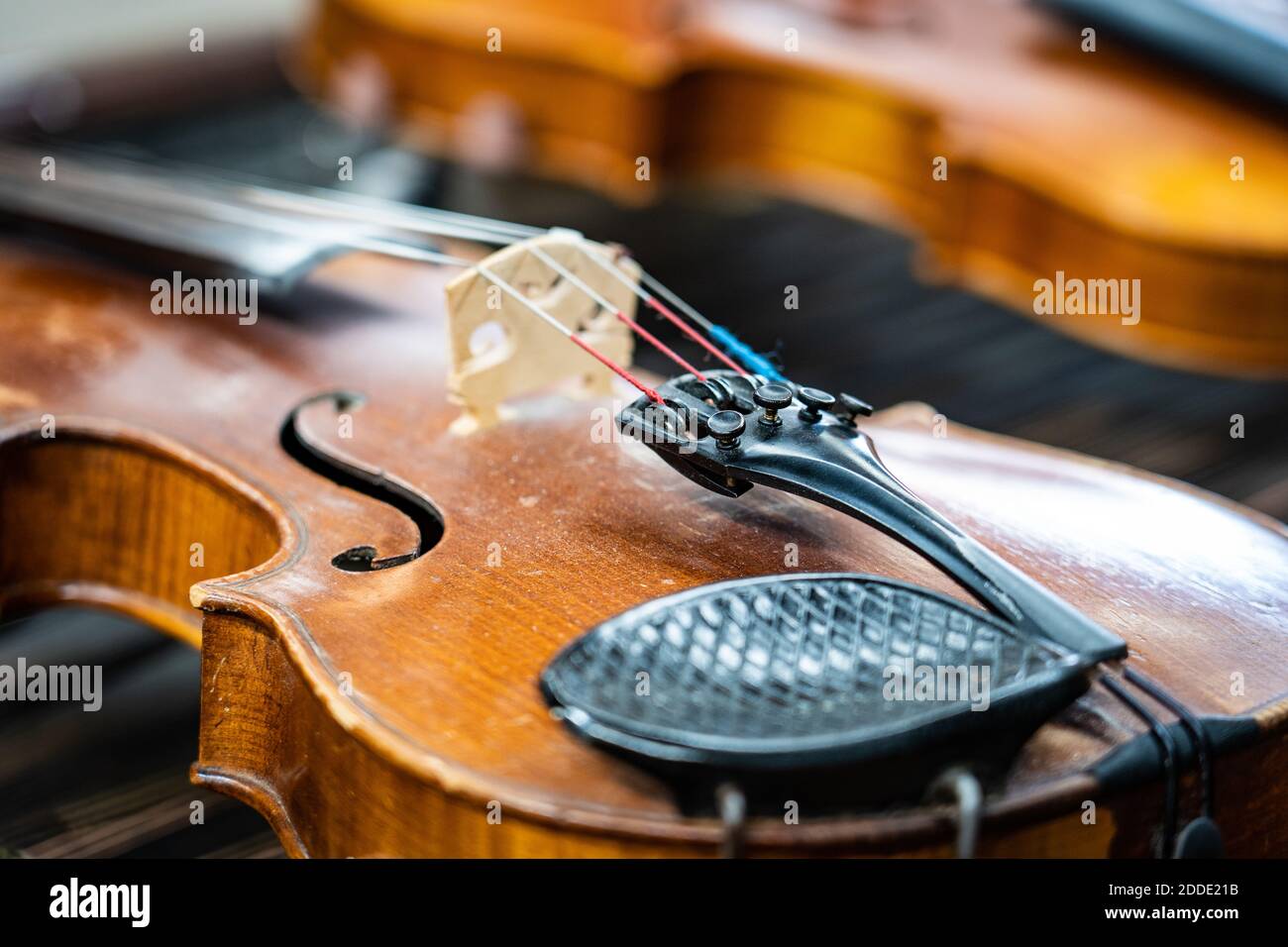 Antique violin and violin bow lying on dulcimer. Close up a violin instrument and cymbal before a concert. Music concept background Stock Photo