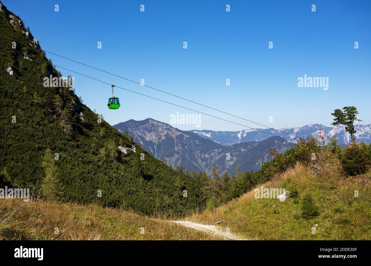 Austria, Upper Austria, Bad Ischl, Overhead cable car moving over forested mountain valley Stock Photo