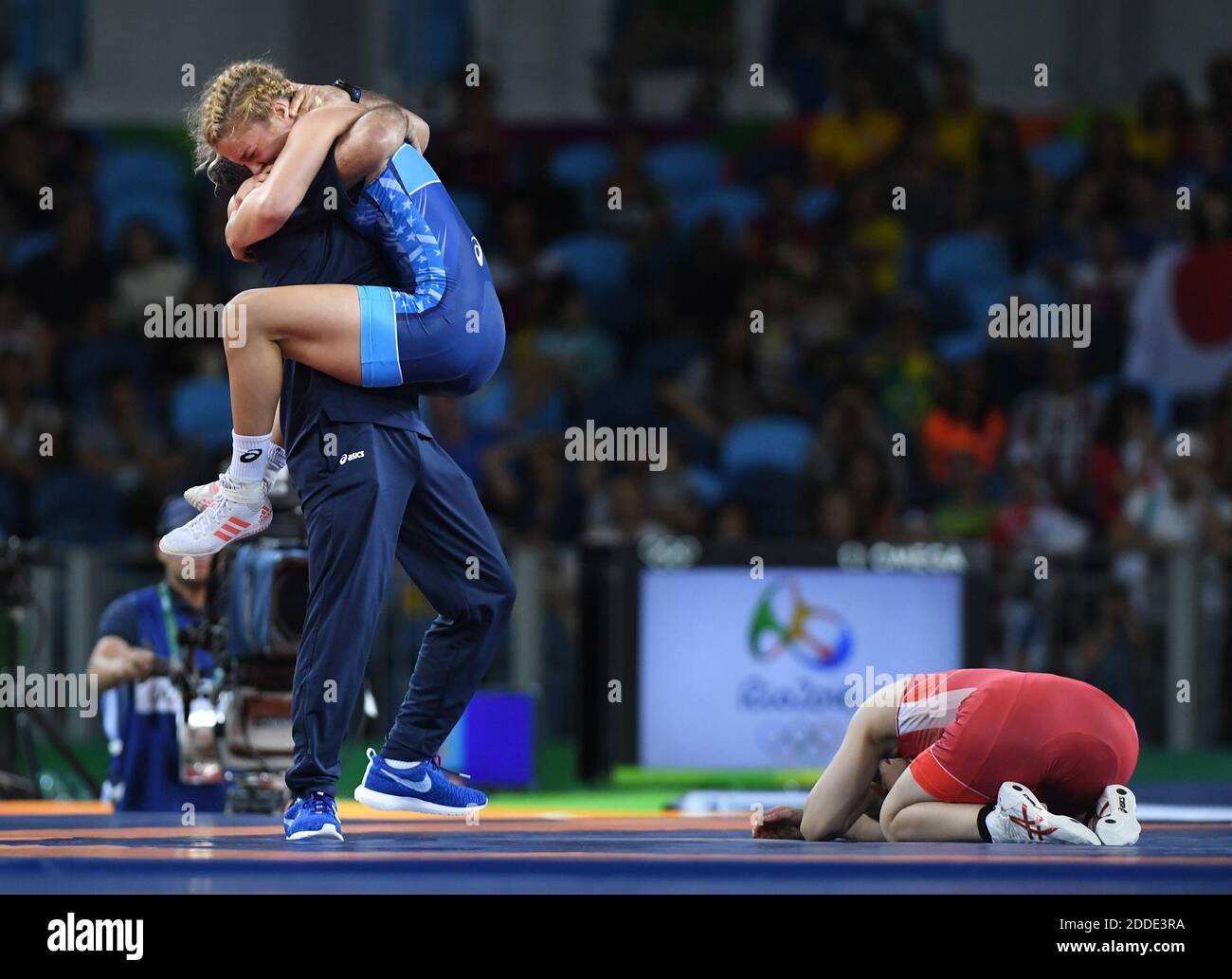 NO FILM, NO VIDEO, NO TV, NO DOCUMENTARY - Japan's Saori Yoshida buries her face in the mat as U.S. wrestler Helen Maroulis celebrates her gold-medal win in the 53kg wrestling final on Thursday, August 18, 2016, at the Olympic Games in Rio de Janeiro, Brazil. Maroulis won, a first for a U.S. woman. Photo by Mark Reis/Colorado Springs Gazette/TNS/ABACAPRESS.COM Stock Photo