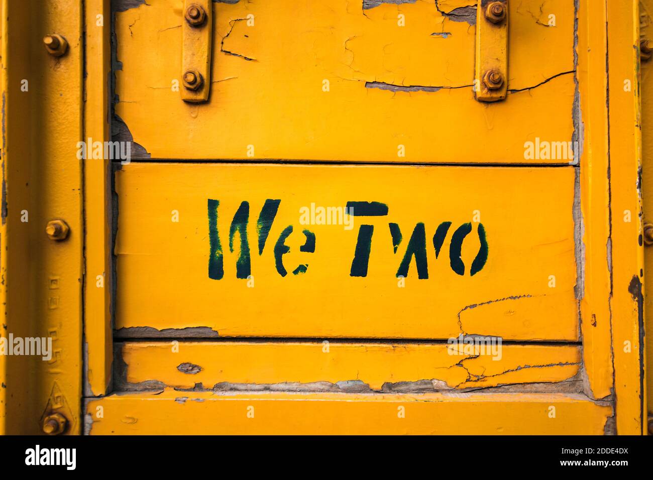 Short phrase on side of yellow weathered truck Stock Photo