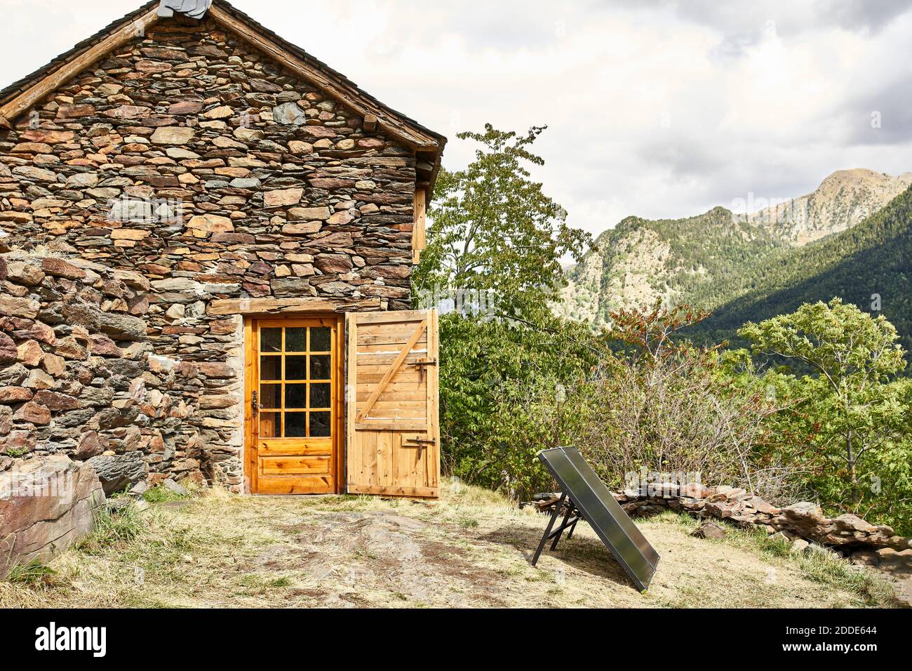 Old traditional house in between mountains Stock Photo