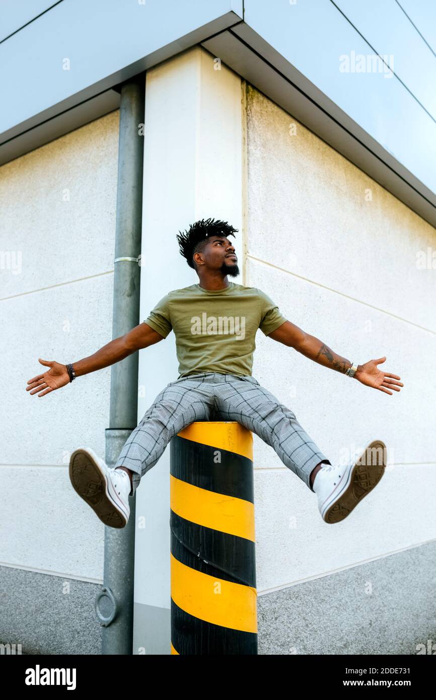 Man sitting on bollard hires stock photography and images Alamy