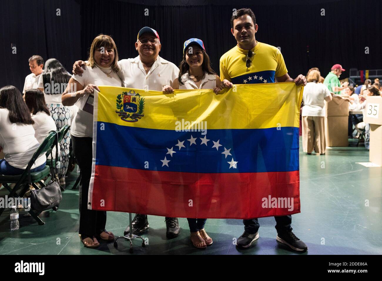 NO FILM, NO VIDEO, NO TV, NO DOCUMENTARY - Maritza Heredia, Eddison Heredia, Janale Carruyo and Orlando Jimenez hold up a Venezuelan flag after voting in the country's referendum at the Watsco Center in Coral Gables on Sunday, July 16, 2017. Photo by Bryan Cereijo/Miami Herald/TNS/ABACAPRESS.COM Stock Photo