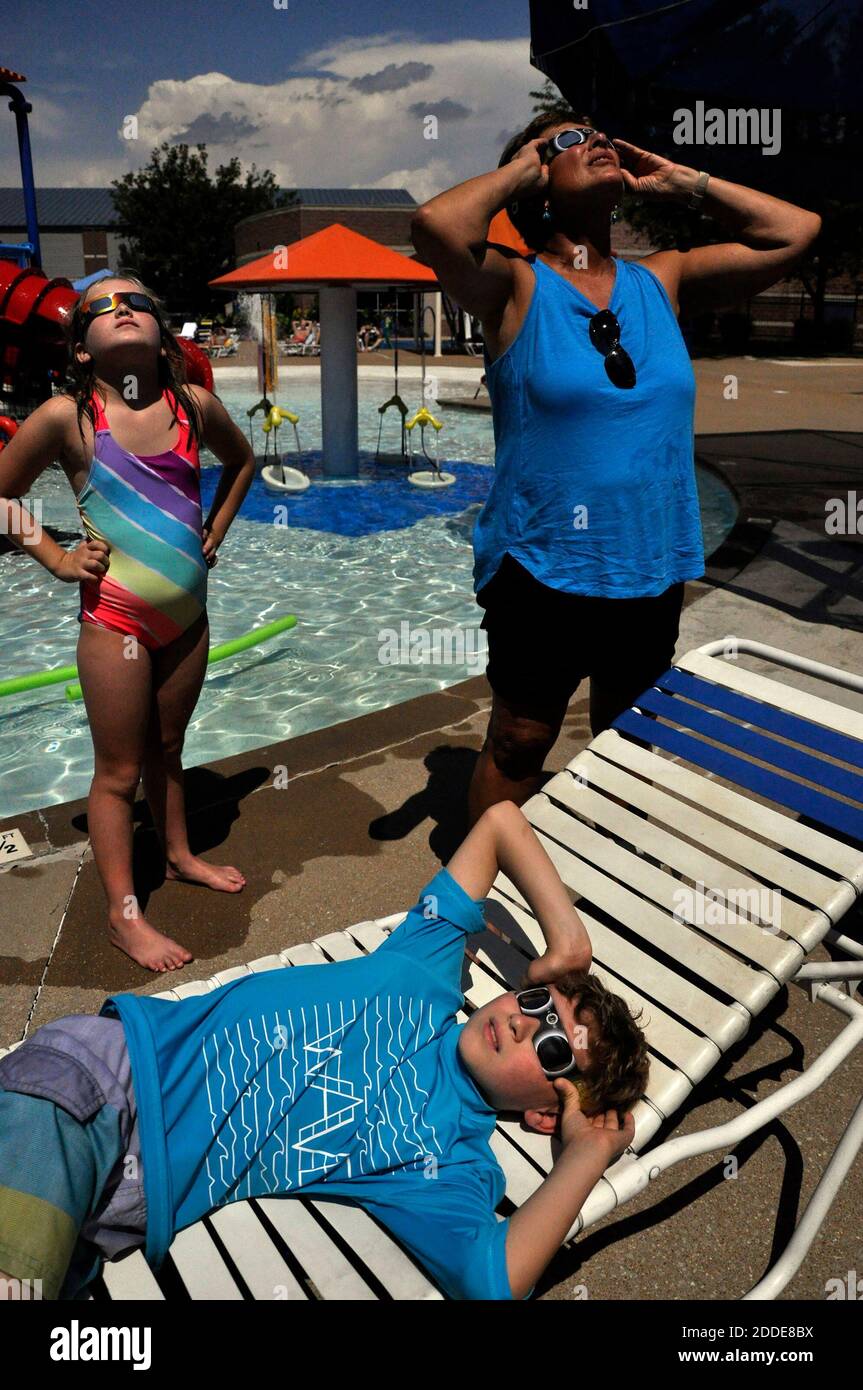 NO FILM, NO VIDEO, NO TV, NO DOCUMENTARY - As the moment of totality rapidly approaches, Henry Jennings, 10, in front, his sister Lucy Jennings, 8, and their grandmother Mary Kinney, all of Webster Groves, make sure their glasses are properly on. The pool at the Webster Groves Rec Center opened for special hours Monday, Aug. 21, 2017 for eclipse-watchers. Photo by Hillary Levin/St. Louis Post-Dispatch/TNS/ABACAPRESS.COM Stock Photo