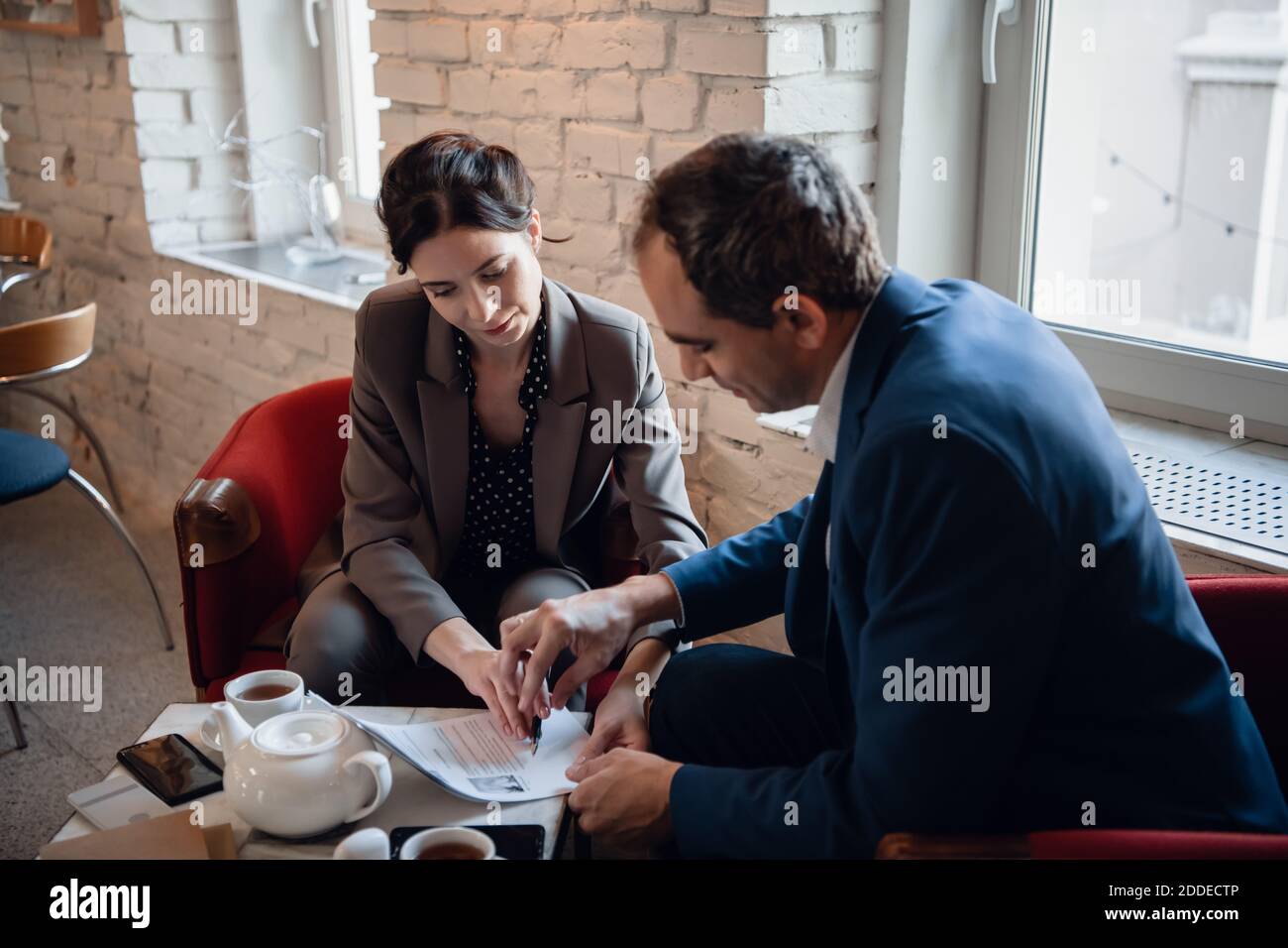Businessman And Businesswoman Meeting In Coffee Shop Stock Photo - Alamy