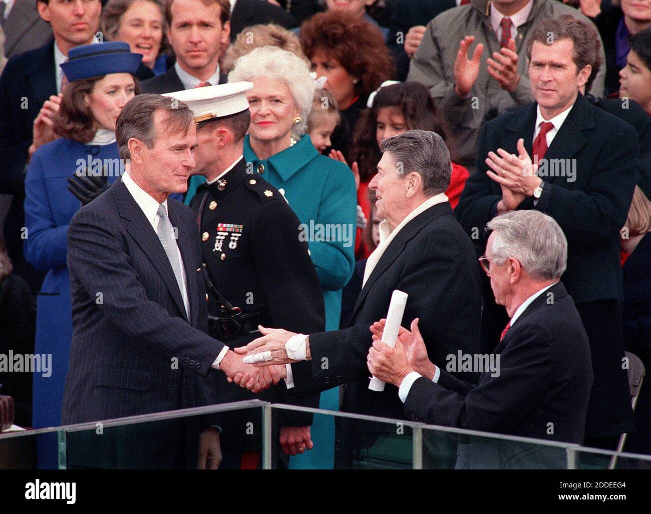 NO FILM, NO VIDEO, NO TV, NO DOCUMENTARY - Newly-inaugurated president George H.W. Bush. shakes hands with Ronald Reagan as George W. Bush (far right), First Lady Barbara Bush (center) and Marilyn Quayle (far left) applaud during Bush's swearing-in ceremony, Jan. 20, 1989, in Washington, D.C. George H.W. Bush died Friday, Nov. 30, 2018, at the age of 94. Photo by Joe Burbank/Orlando Sentinel/TNS/ABACAPRESS.COM Stock Photo