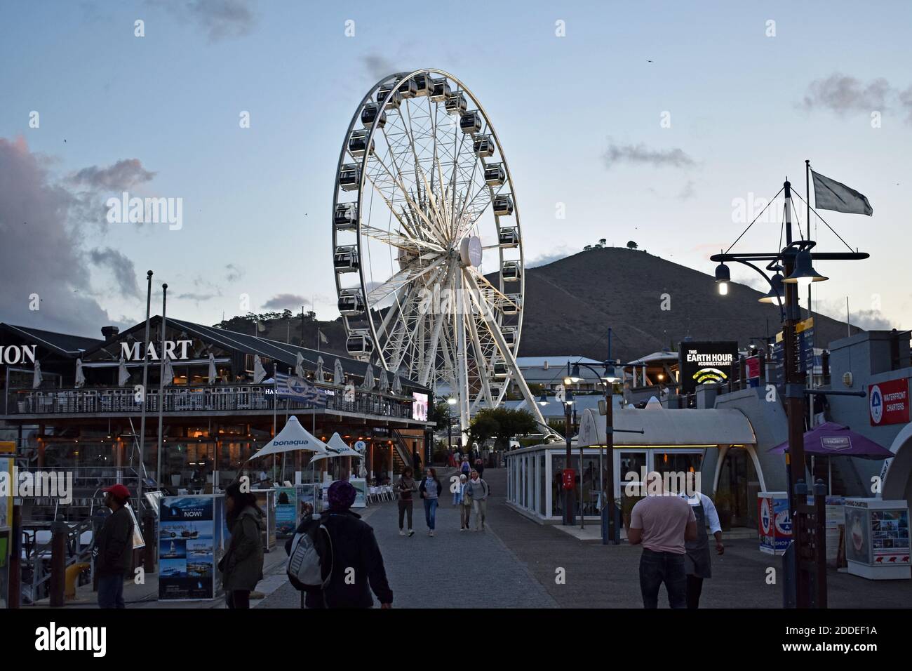 The Cape Wheel on the V&A Waterfront. Tourists ad visitors wander