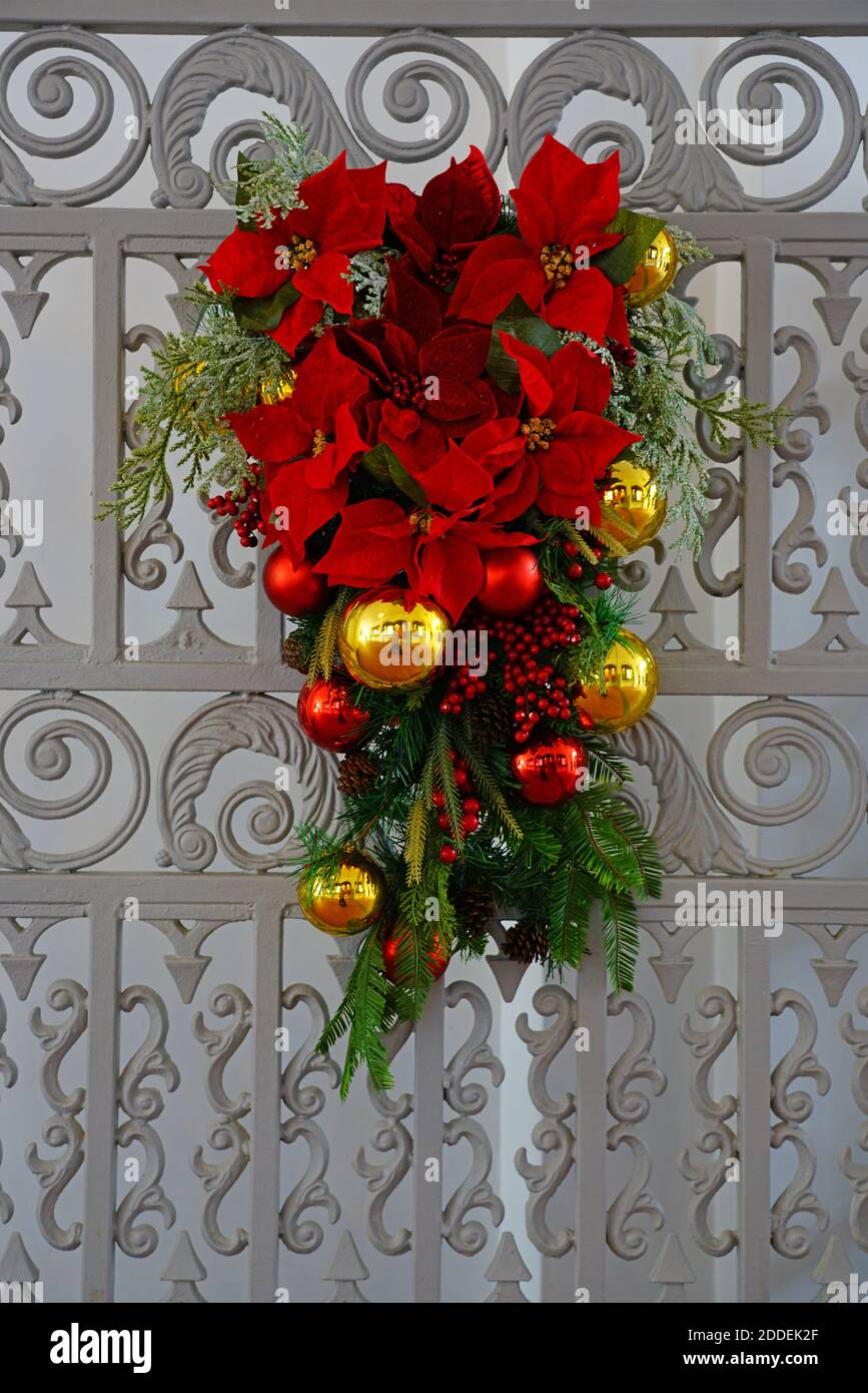 Christmas holiday pine swag with poinsettia flowers and red bow Stock Photo