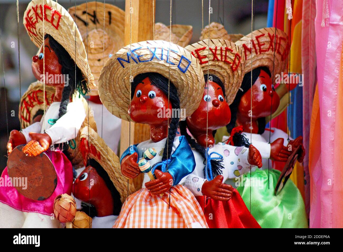 Mexican Souvenir Marionettes Hanging In A Tourist Store Are Painted And Dressed To Represent The Culture And People Exaggerating Cultural Stereotypes Like The Marionettes Is Offensive To Many Which Brings To Question