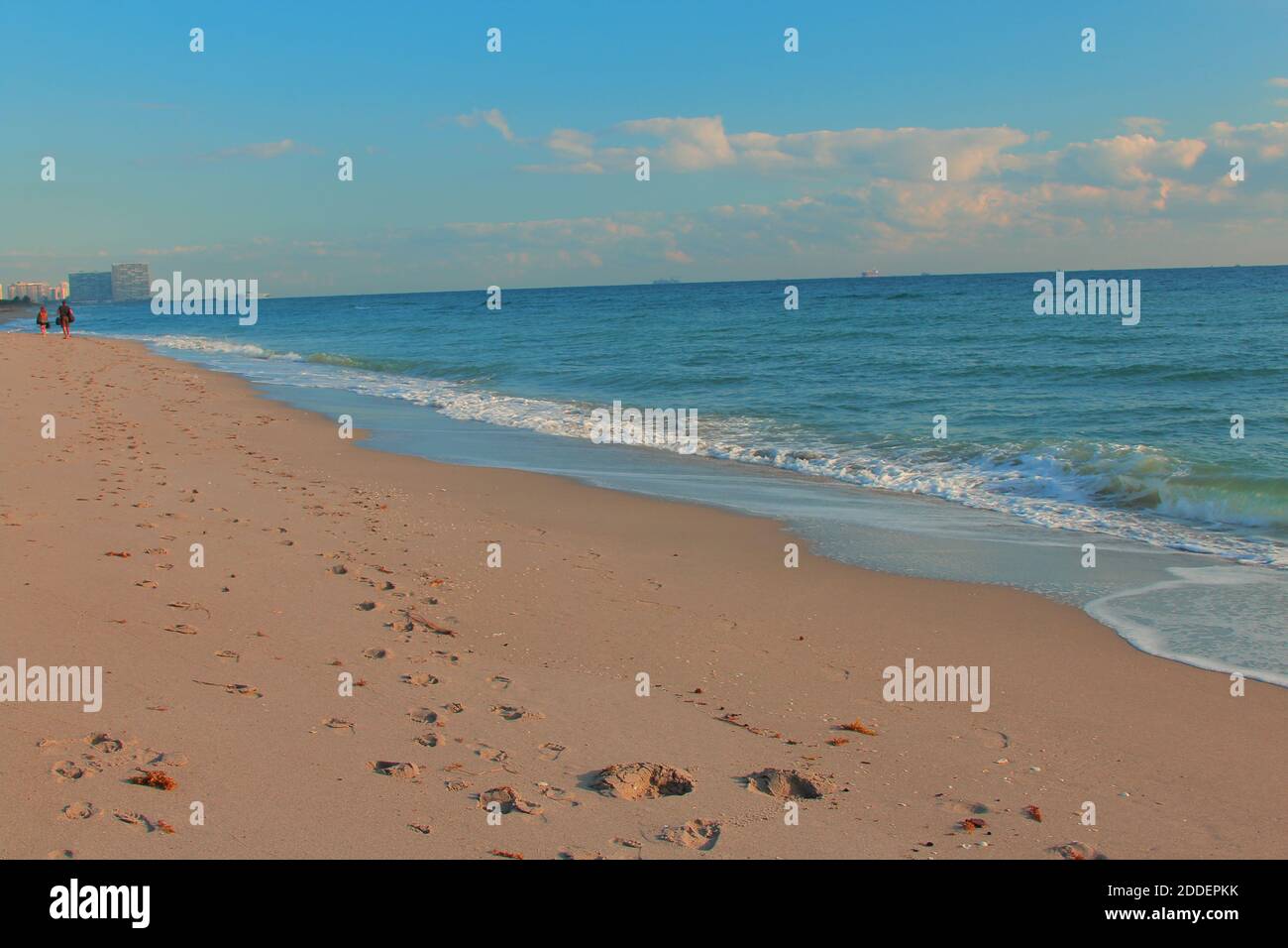 Footprints on the shore and a peaceful ocean Stock Photo
