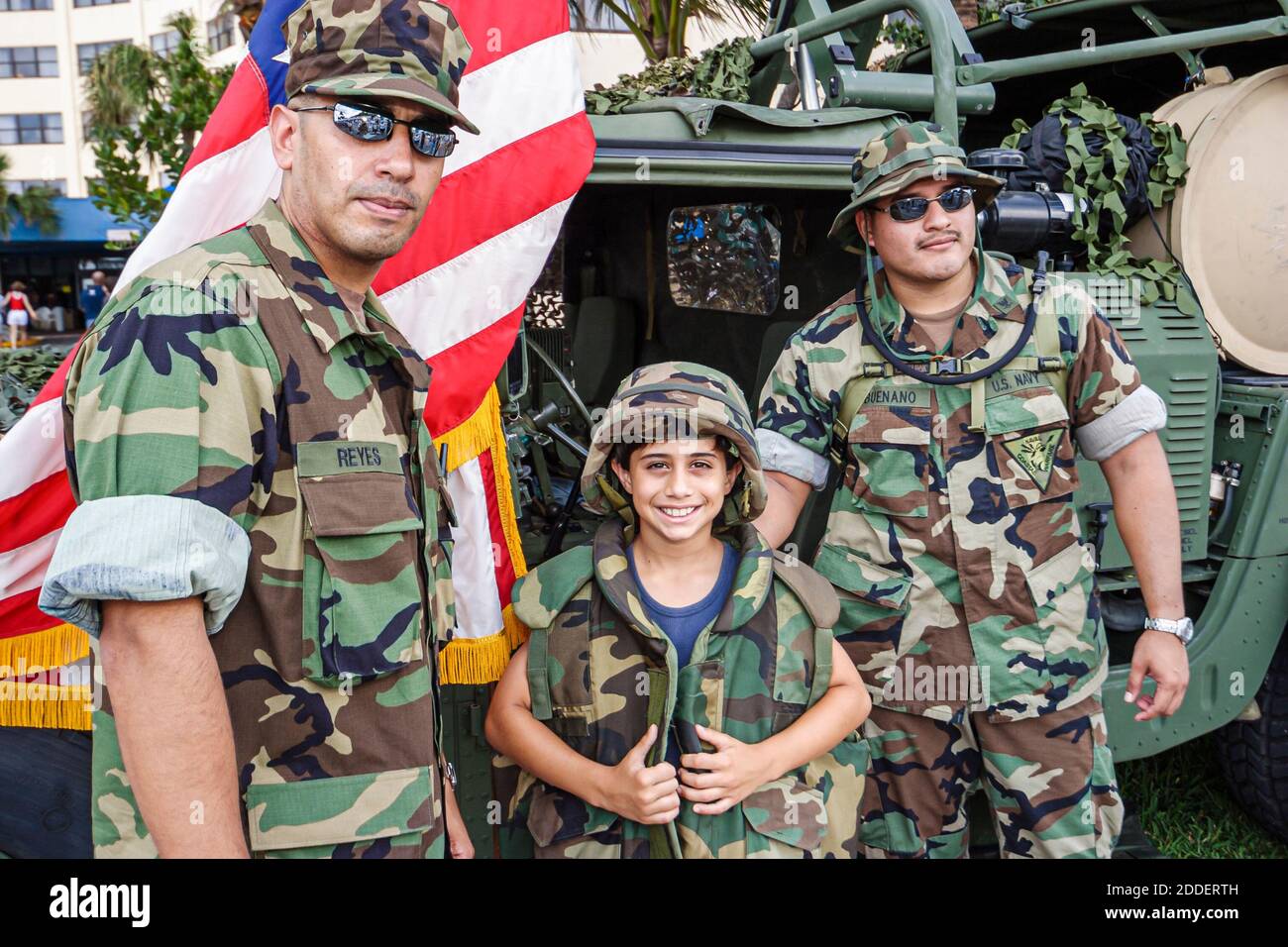 Florida Ft. Fort Lauderdale Beach Air & Sea Show military,boy wearing wears tries on uniform,men soldiers National Guard, Stock Photo