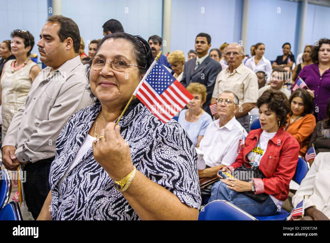 Florida,Miami Beach Convention Center,centre,naturalization ceremony oath of citizenship Pledge Allegiance,immigrant immigrants holding small miniatur Stock Photo