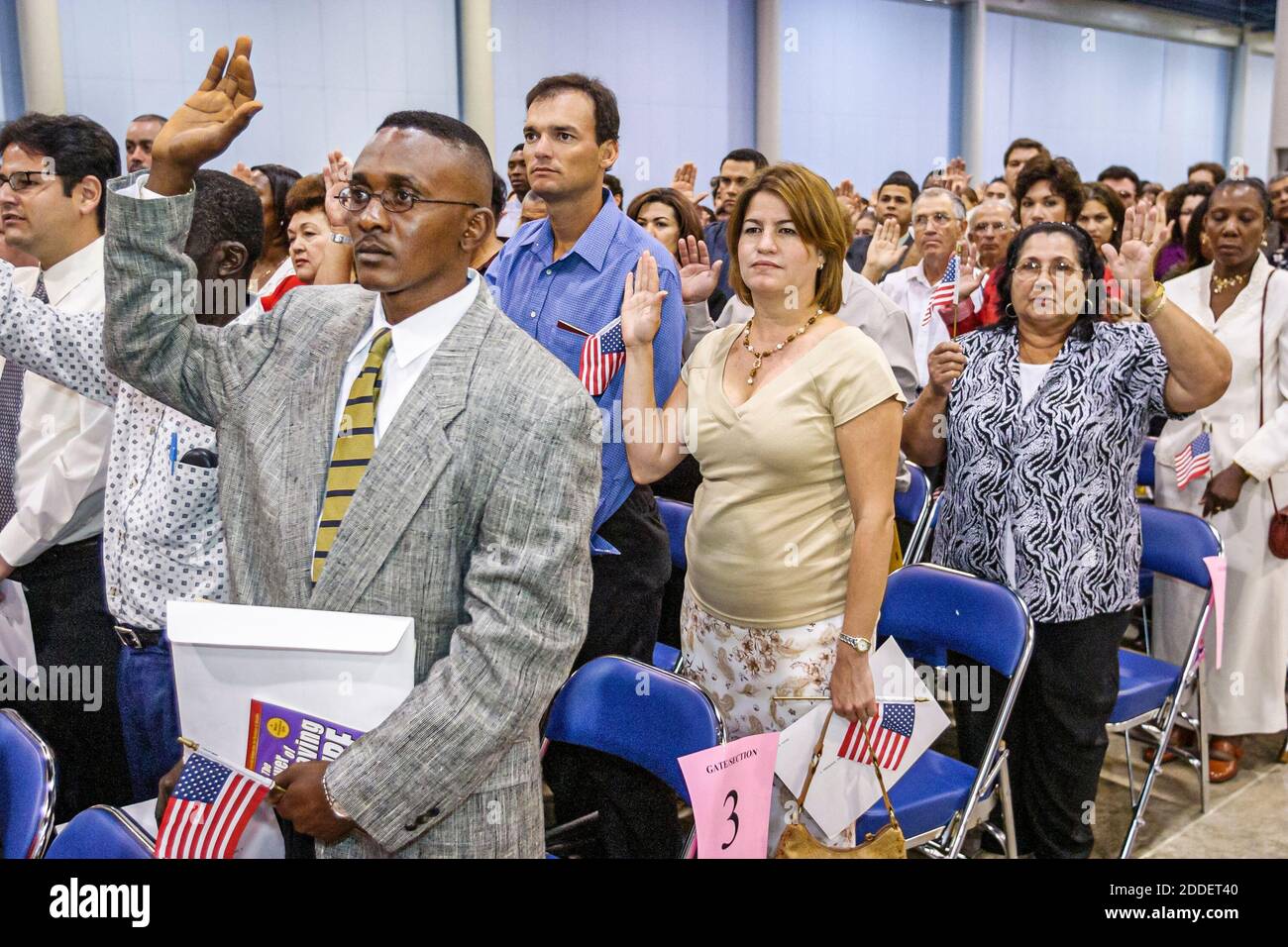 Florida,Miami Beach Convention Center,centre,naturalization ceremony oath of citizenship Pledge Allegiance,immigrants Black Hispanic women man recite Stock Photo