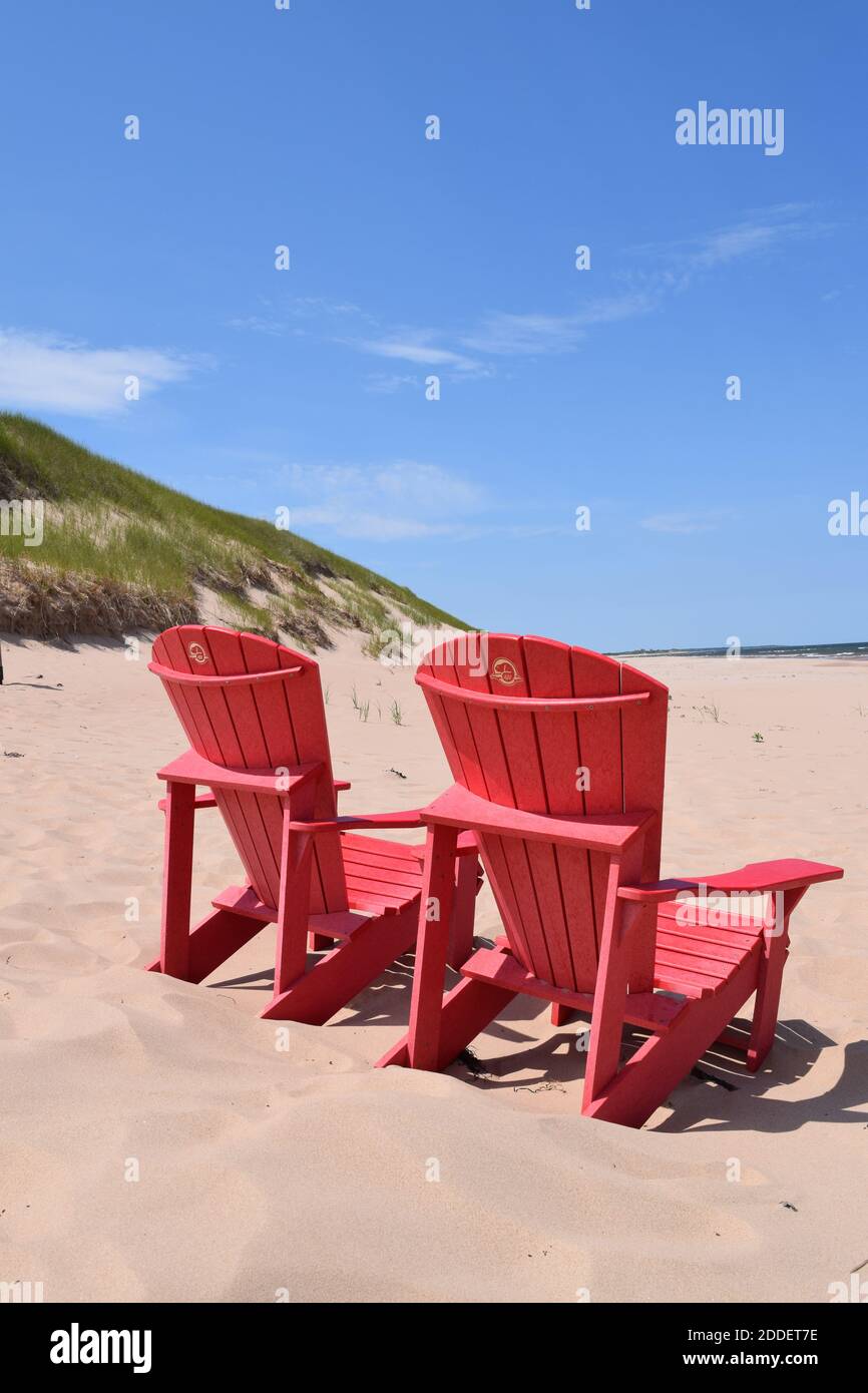 Parks Canada red chairs on beach on Atlantic Ocean Canada Stock Photo