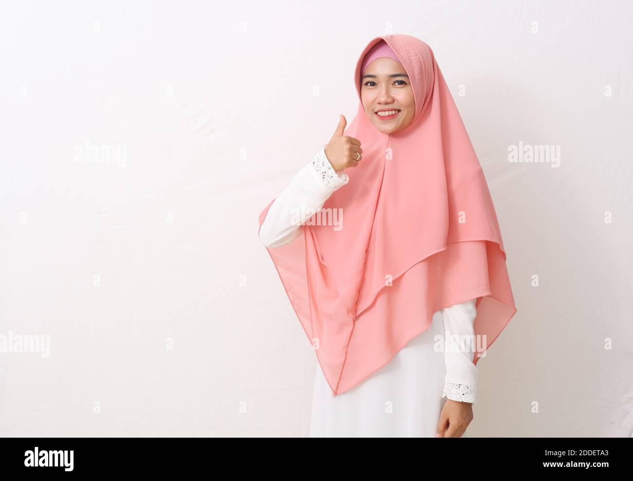 A portrait of happy asian muslim woman wearing a veil or hijab with ...