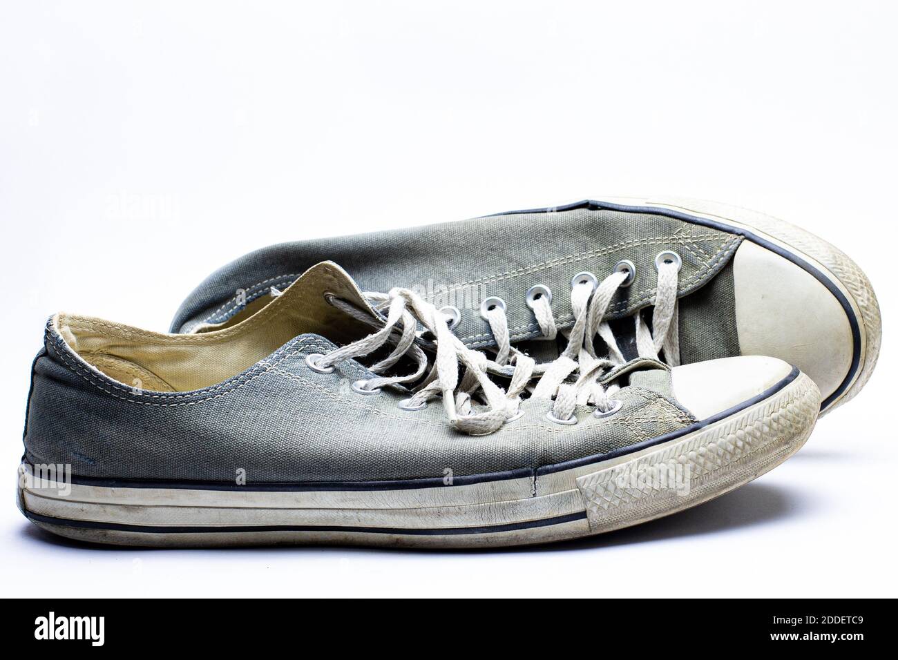 Old dirty sneakers worn out by years of use Stock Photo - Alamy