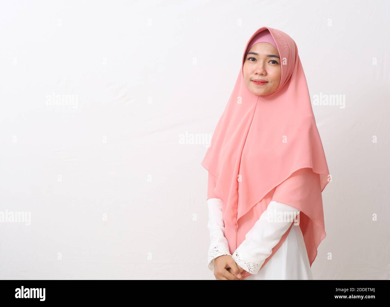 A portrait of happy asian muslim woman wearing a veil or hijab smiling ...