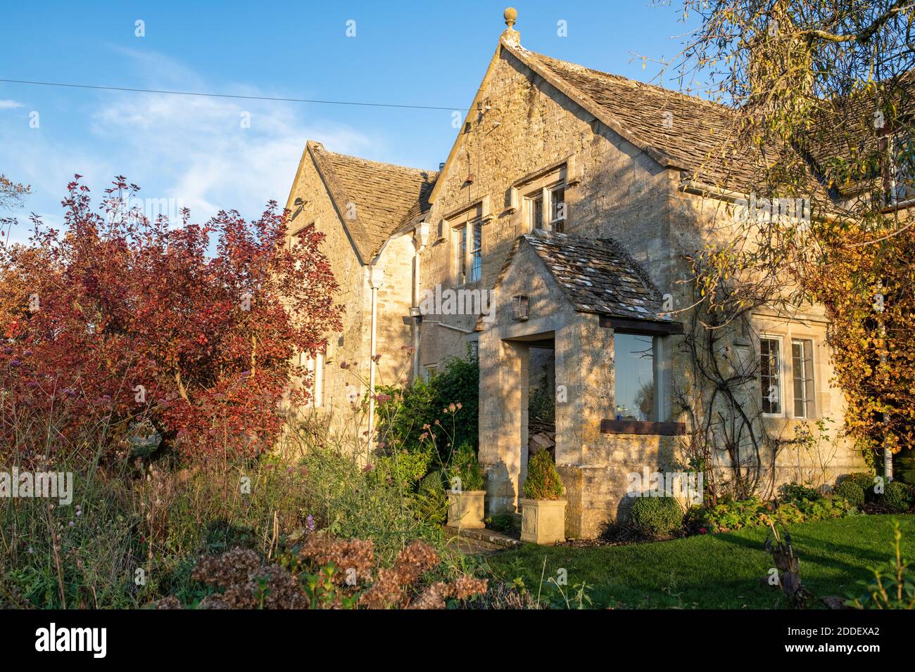 Cotswold stone house in autumn afternoon sunlight in the village of