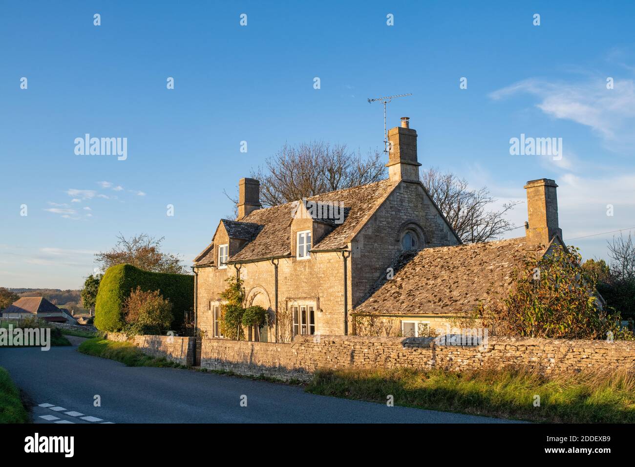 Cotswold stone house in autumn afternoon sunlight in the village of Sherborne, Cotswolds