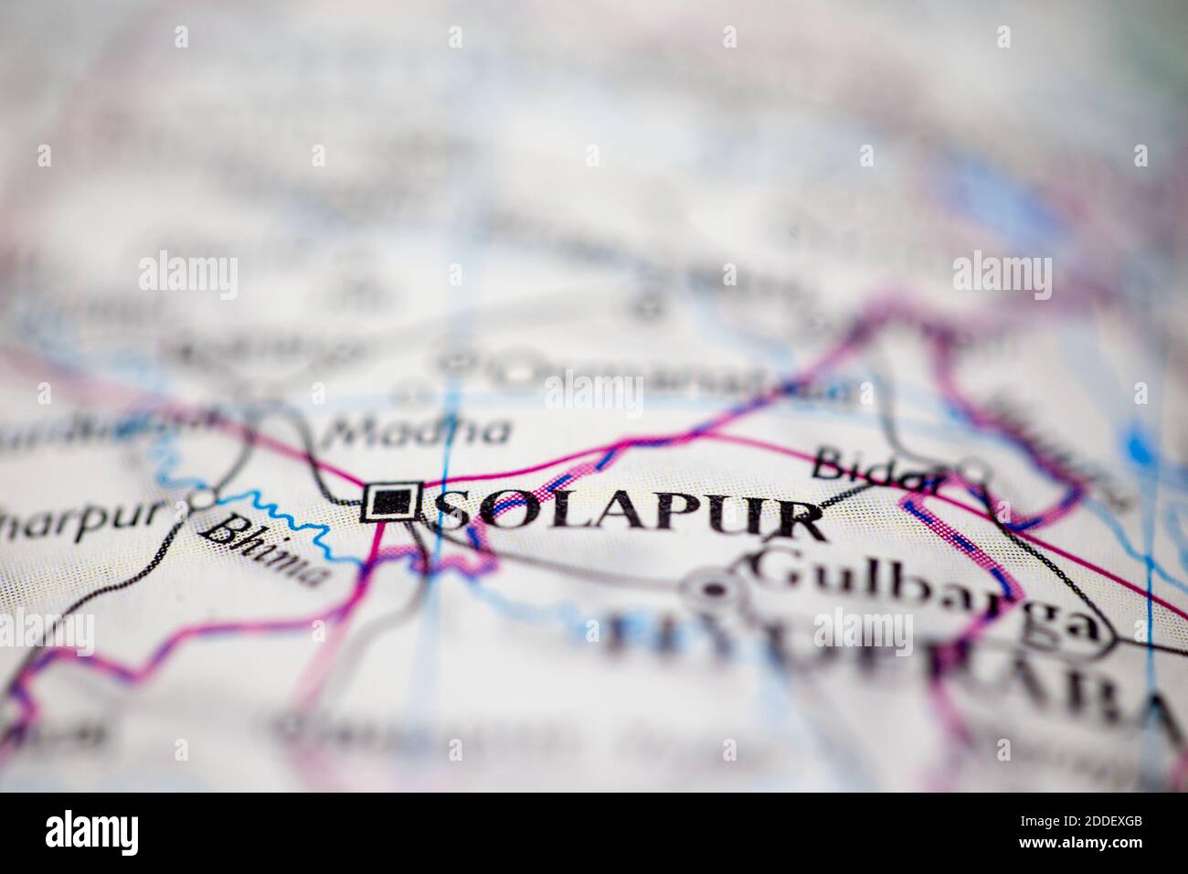 Shallow depth of field focus on geographical map location of Solapur India Asia continent on atlas Stock Photo