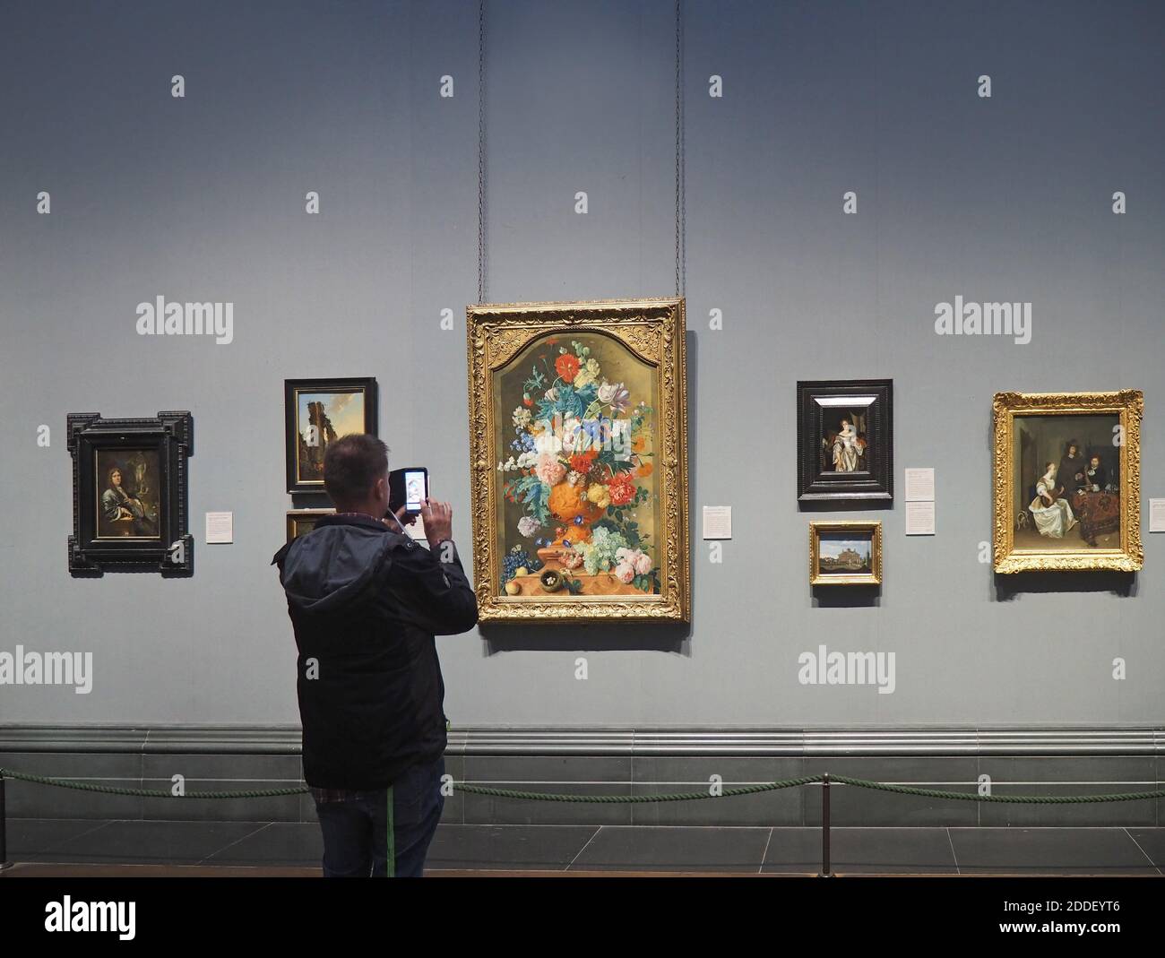 London, England - September 27, 2016:  A visitor admires the old masters at the National Gallery and records it with his telephone camera. Stock Photo