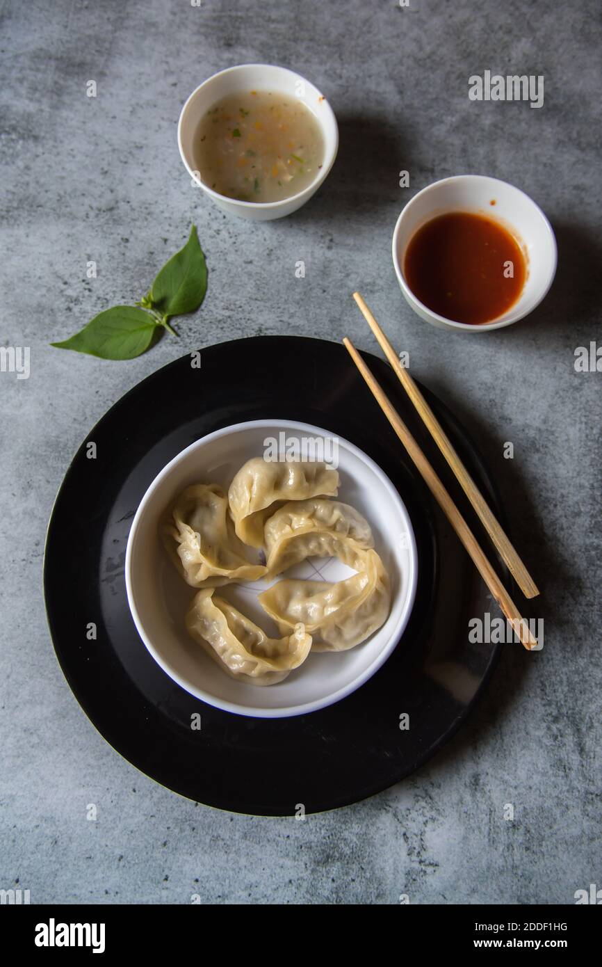 Dim Sum Condiments Vertical view of Dim sums in a plate with condiments Stock Photo - Alamy