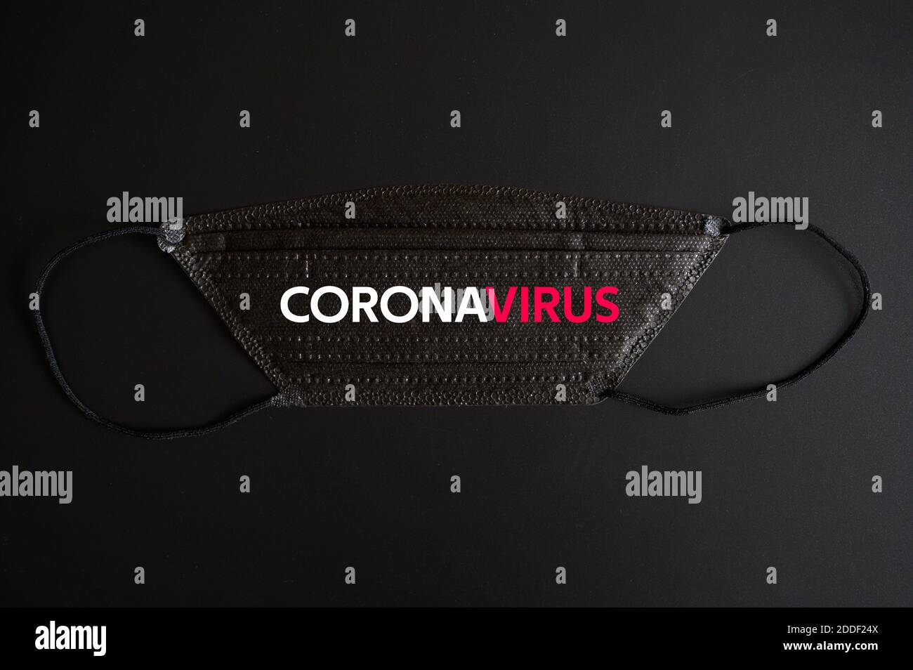 medical protective disposable black mask with CORONAVIRUS text. concept protection of outbreak novel dangerous 2019-nCoV influenza coronavirus, mutate Stock Photo