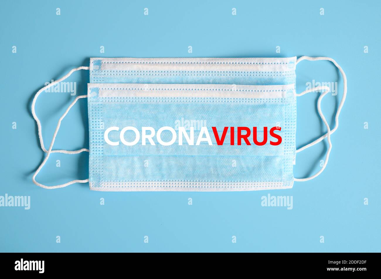 medical protective disposable blue mask with CORONAVIRUS text. concept ...