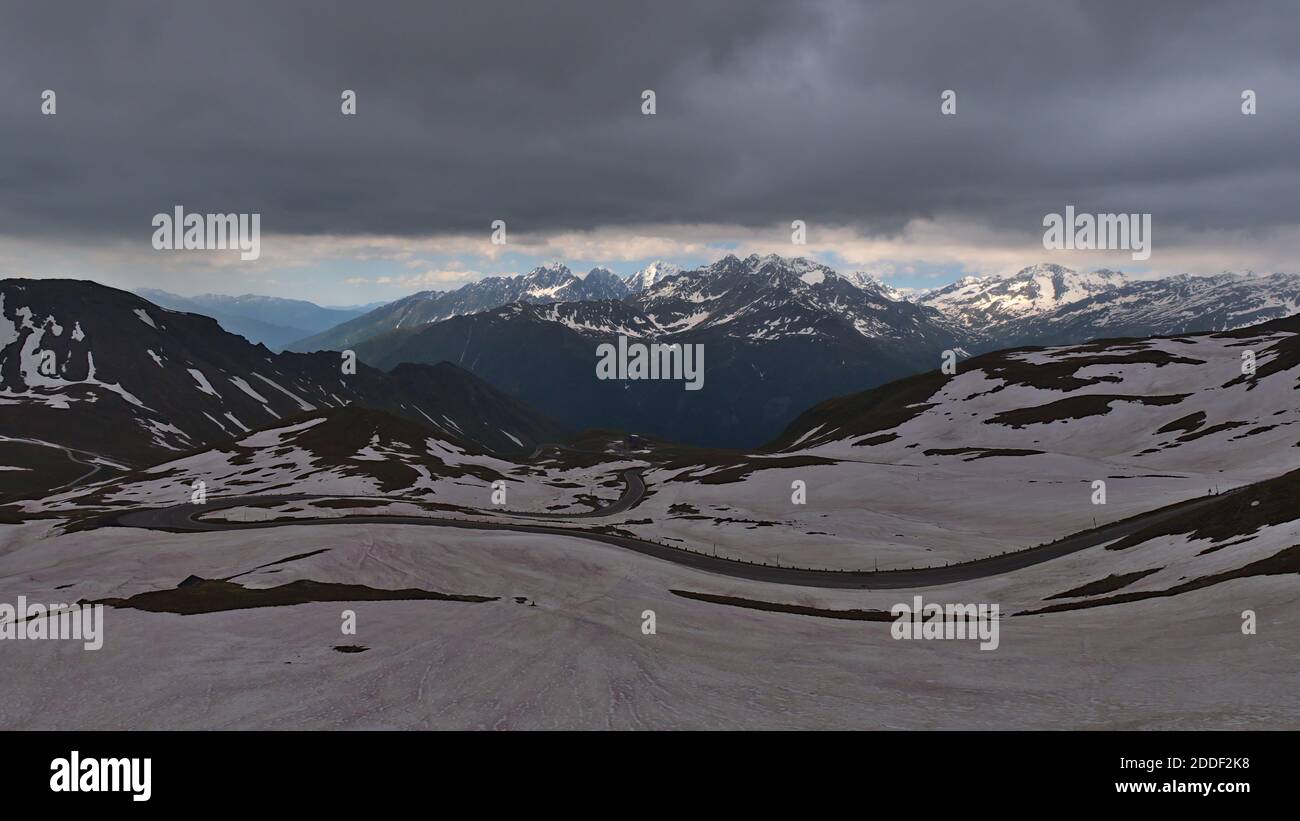 Stunning panorama view of popular mountain pass Grossglockner High Alpine Road in the Alps, Austria in early summer with snow-covered meadows. Stock Photo