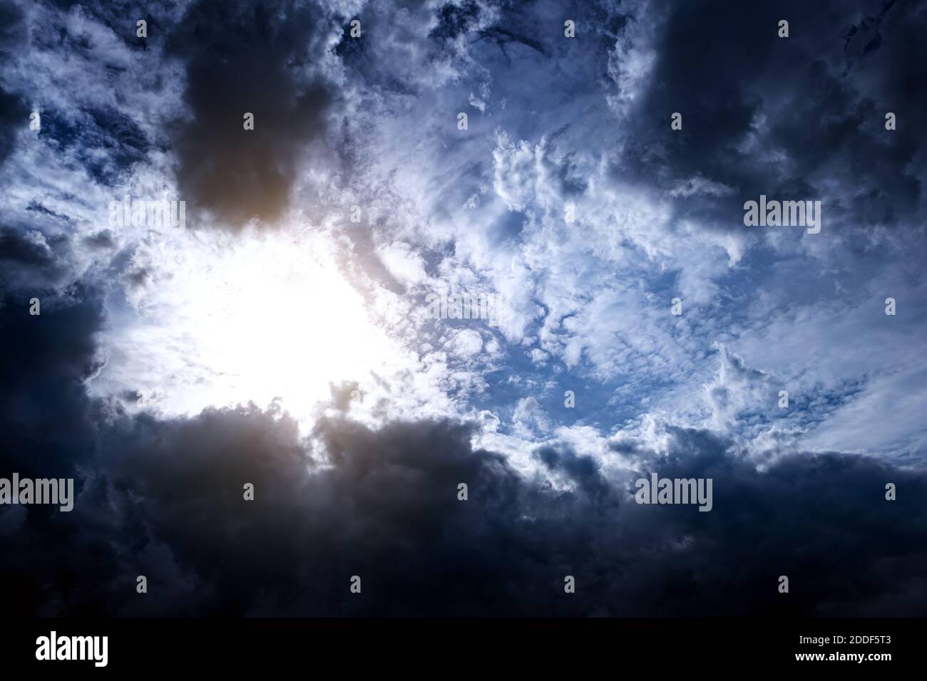 Light in the Dark and Dramatic Storm Clouds Stock Photo