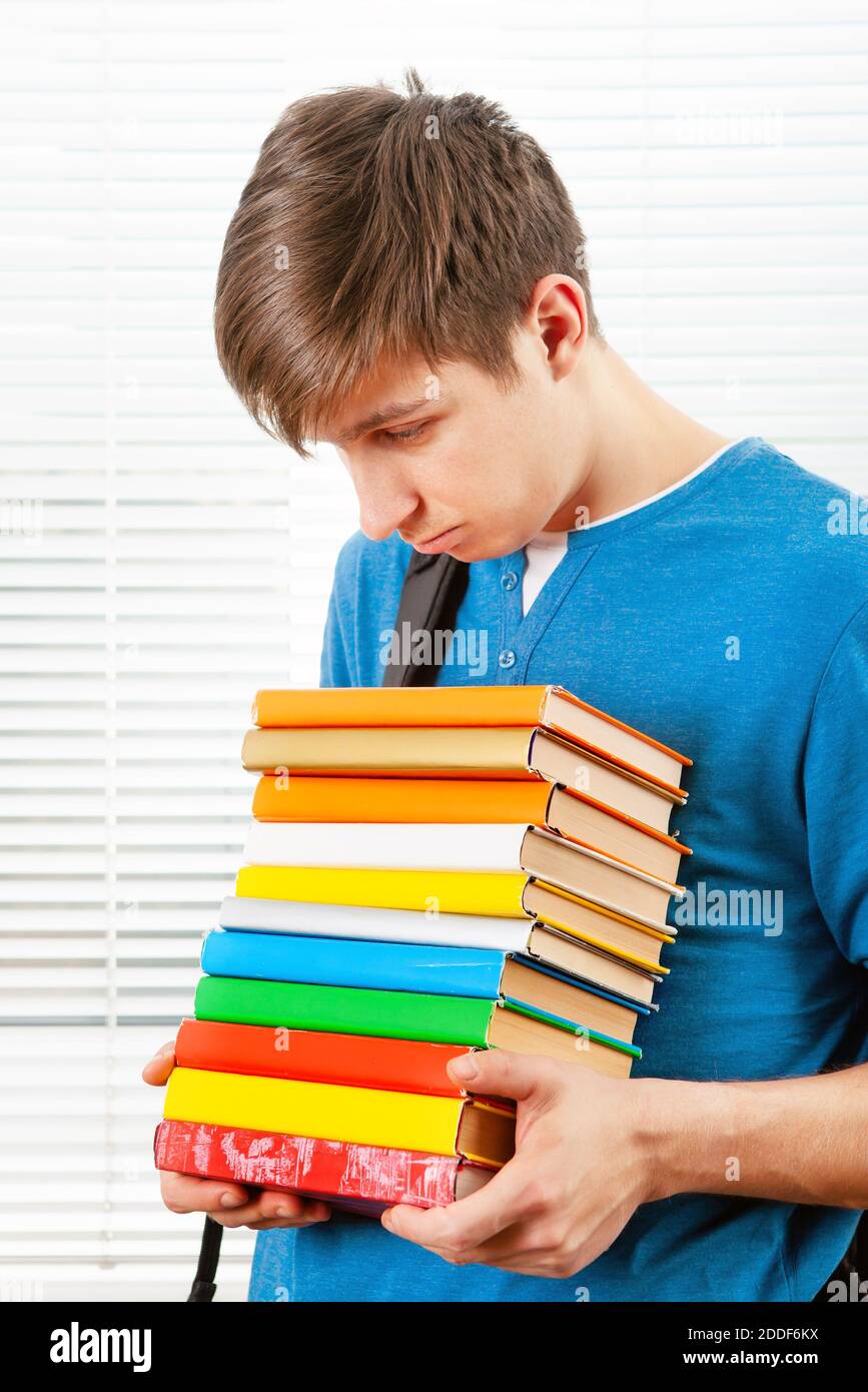Sad Student hold a Books on the Jalousie Background Stock Photo