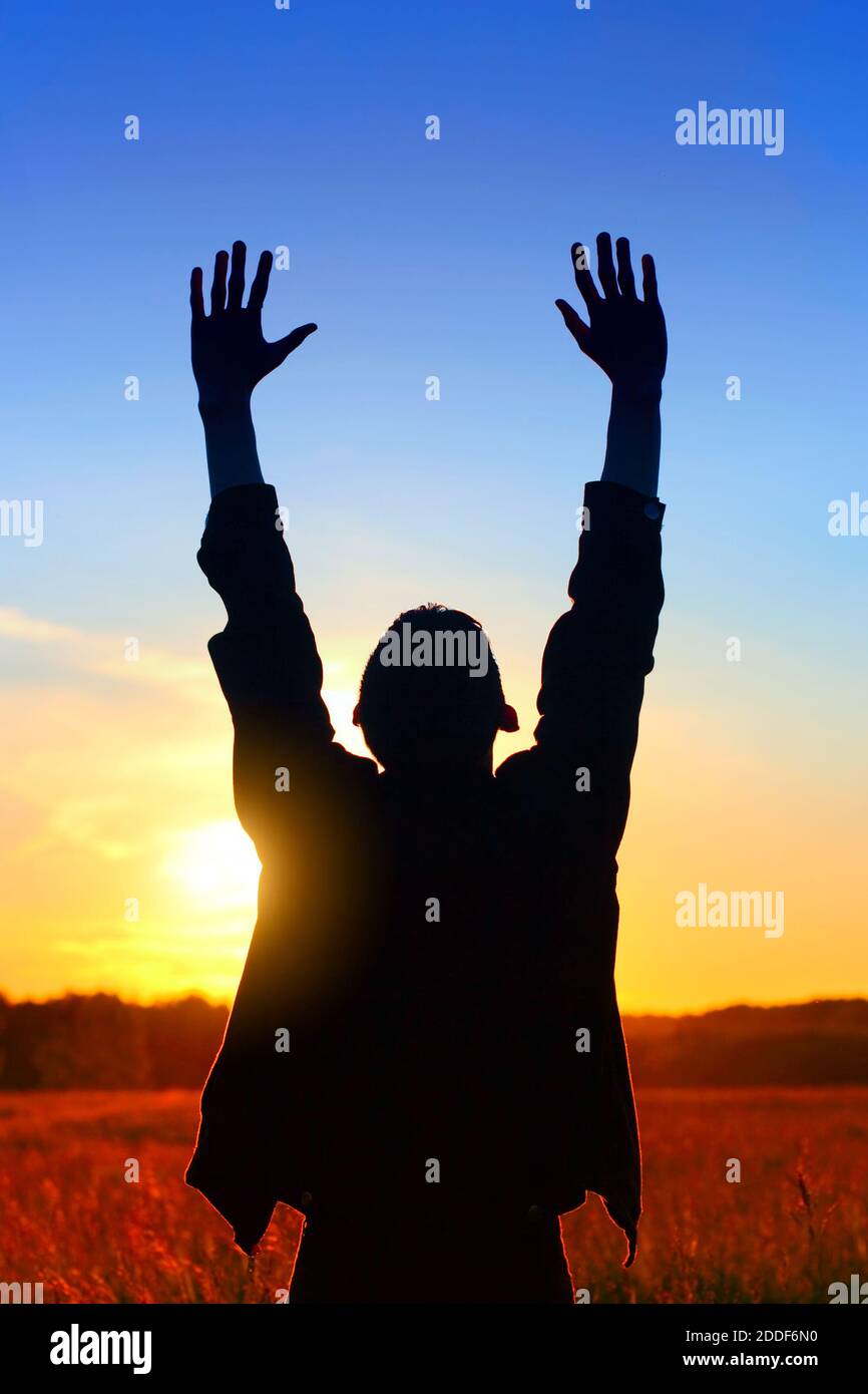 Happy Man Silhouette with Hands Up on the Sunset Background outdoor ...