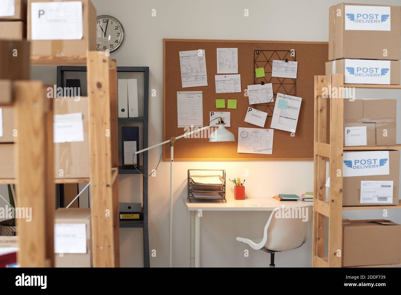Image of board with notes hanging on the wall above the table at empty office Stock Photo