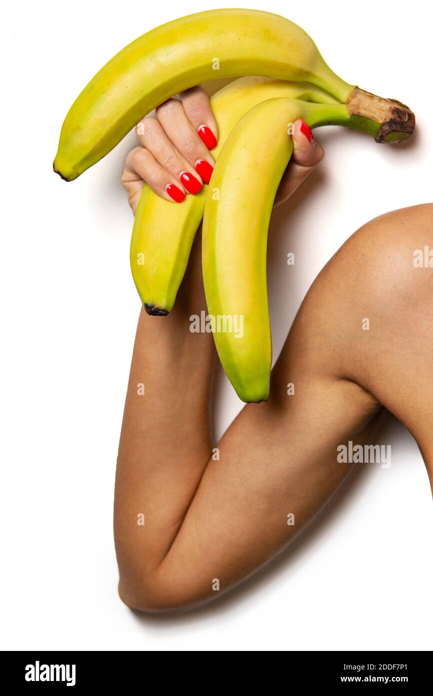 Strong hand with bananas. Powerful vegetable. Healthy food. Stock Photo