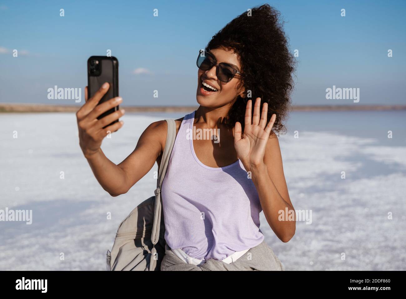 Happy african woman waving hand hi-res stock photography and images - Alamy
