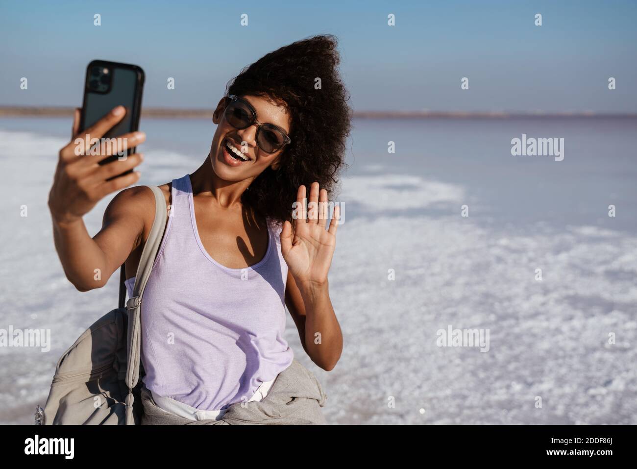 Happy african woman waving hand hi-res stock photography and images - Alamy