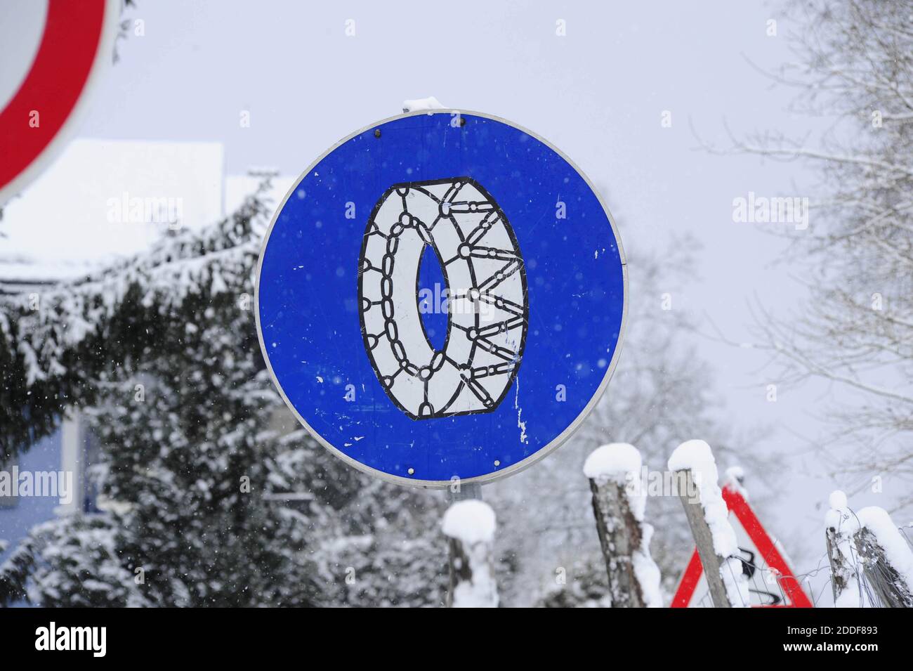 snow chain obligation traffic sign, on a snowy winter road Stock Photo