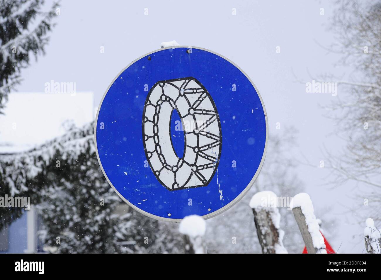 snow chain obligation traffic sign, on a snowy winter road Stock Photo