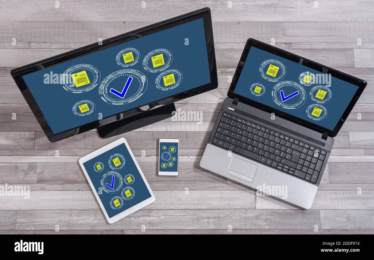 Document validation concept shown on different information technology devices Stock Photo