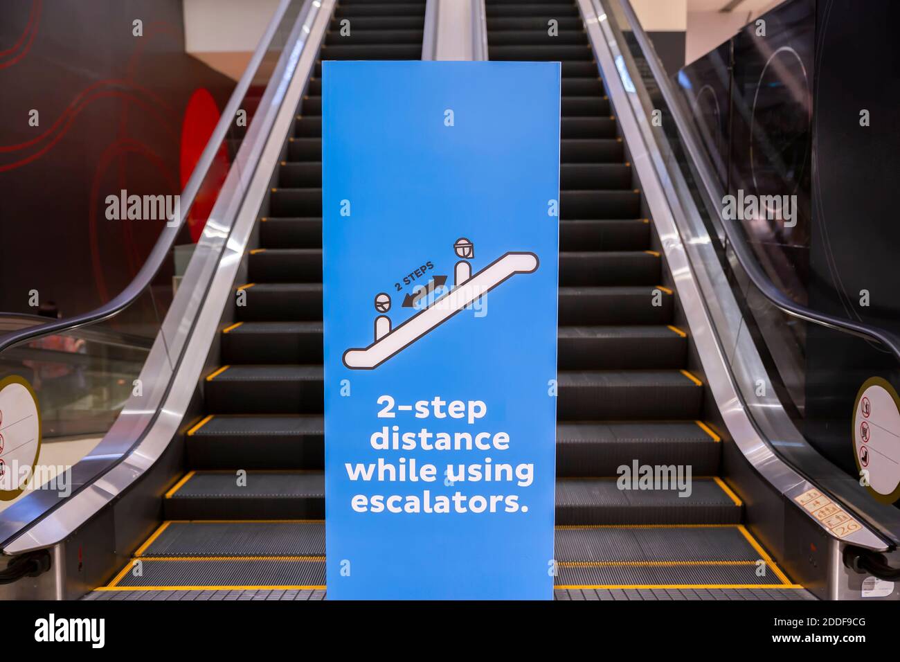 Social distancing sign for warning to keep social distance between each other to protect Coronavirus (CoVID-19) when on escalators.. Stock Photo