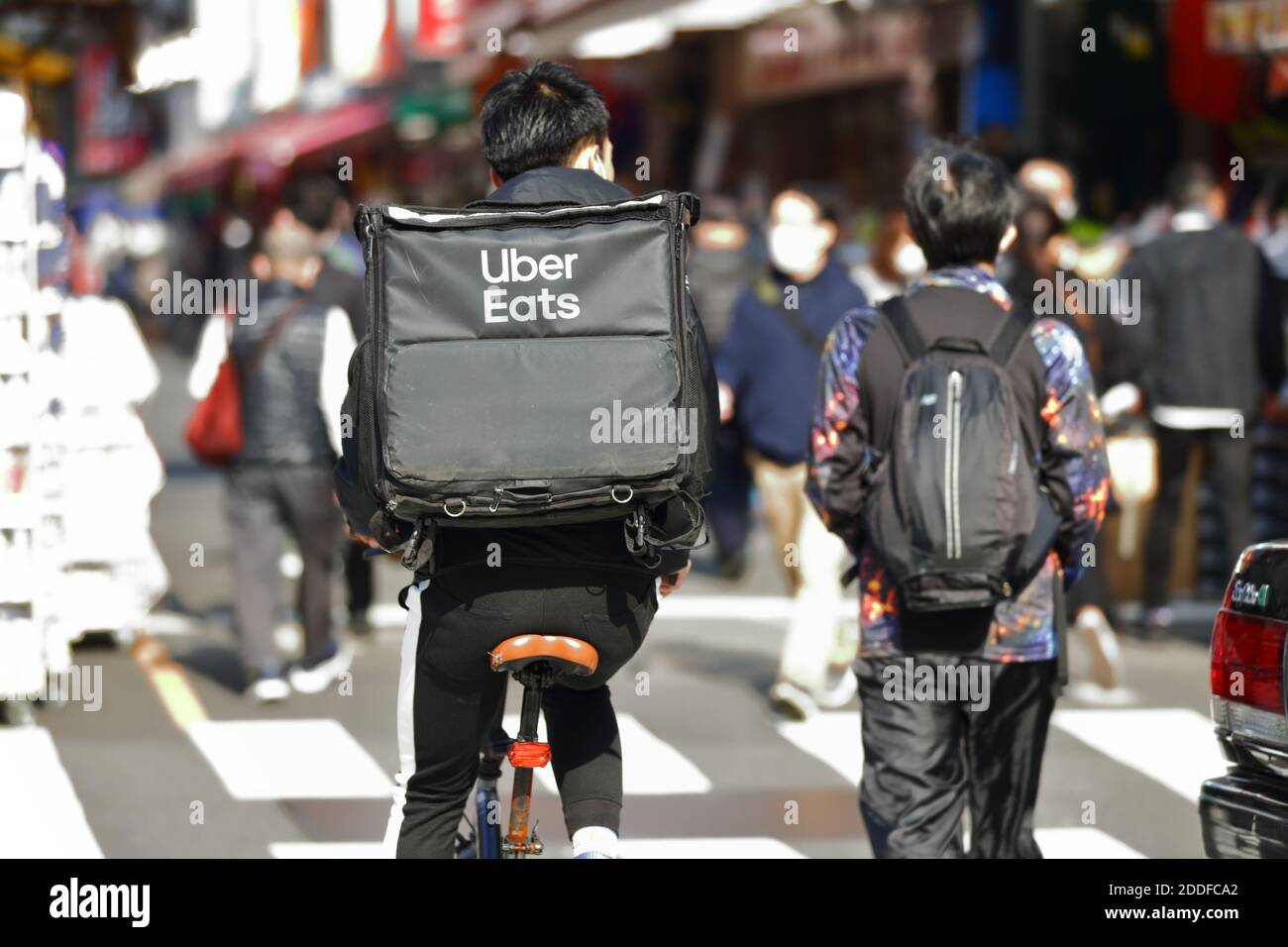 An Uber Eats food delivery courier is seen in Tokyo, Japan on 