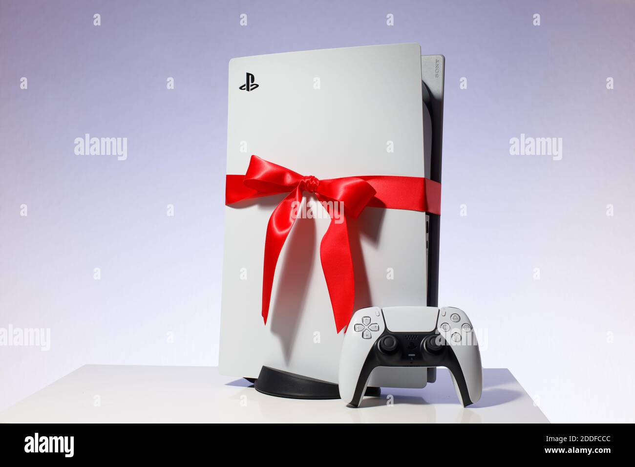 Sony PlayStation 5 game console on black background. Gift edition with red ribbon black friday and Christmas deal Stock Photo
