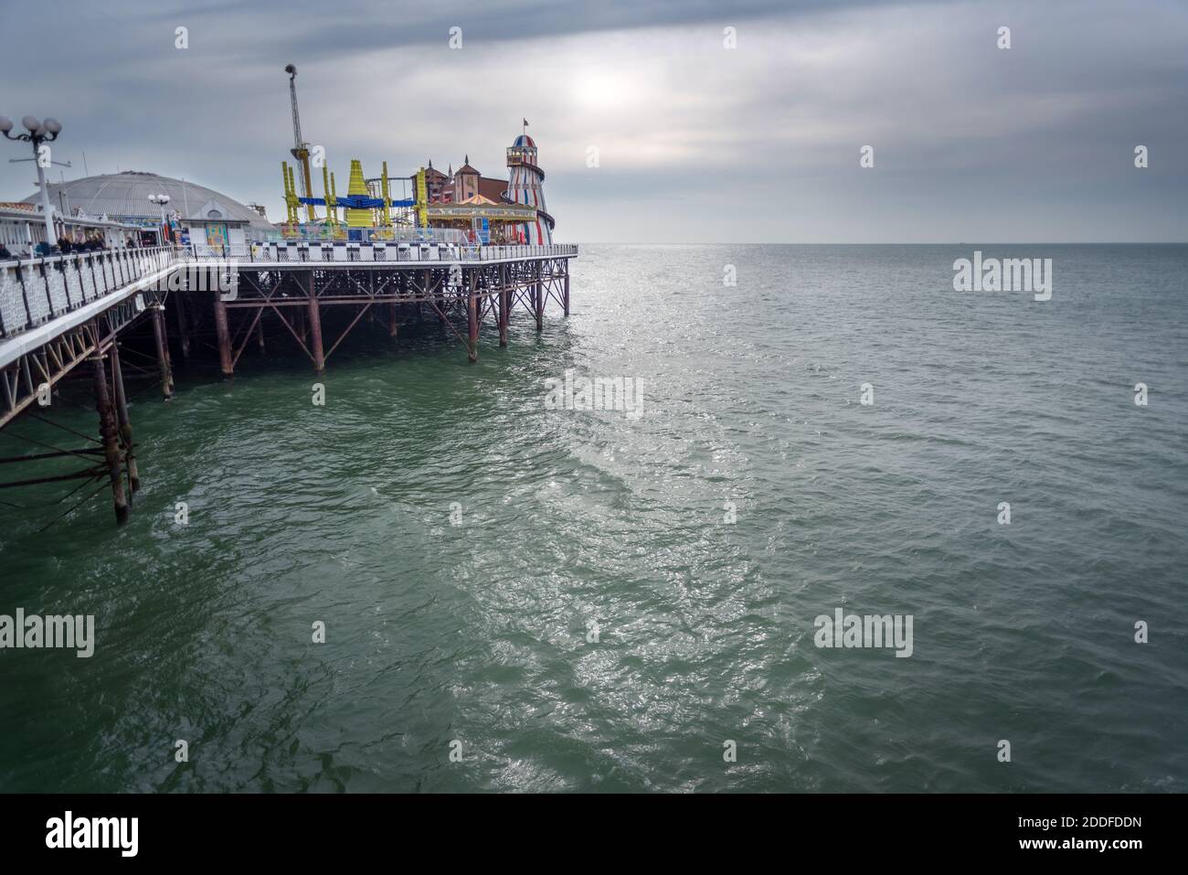 At the iconic Brighton Pier during the winter low season,visitors are few compared to the busy summer months,but it still retains it's allure for pote Stock Photo
