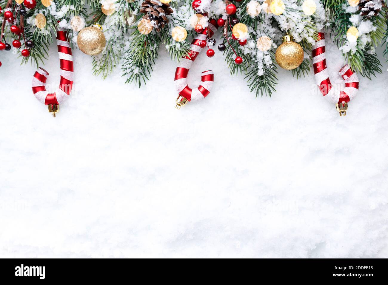 Christmas Border tree branches with golden baubles candies and cones Christmas Border tree branches with golden baubles candies and cones