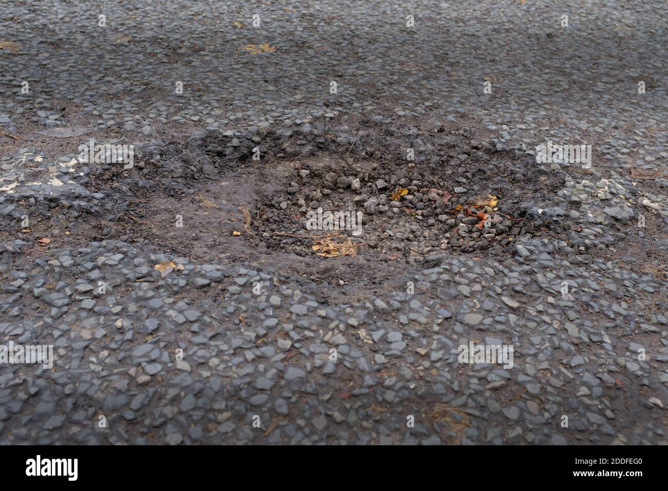 Holes in the un repaired road England Stock Photo Alamy