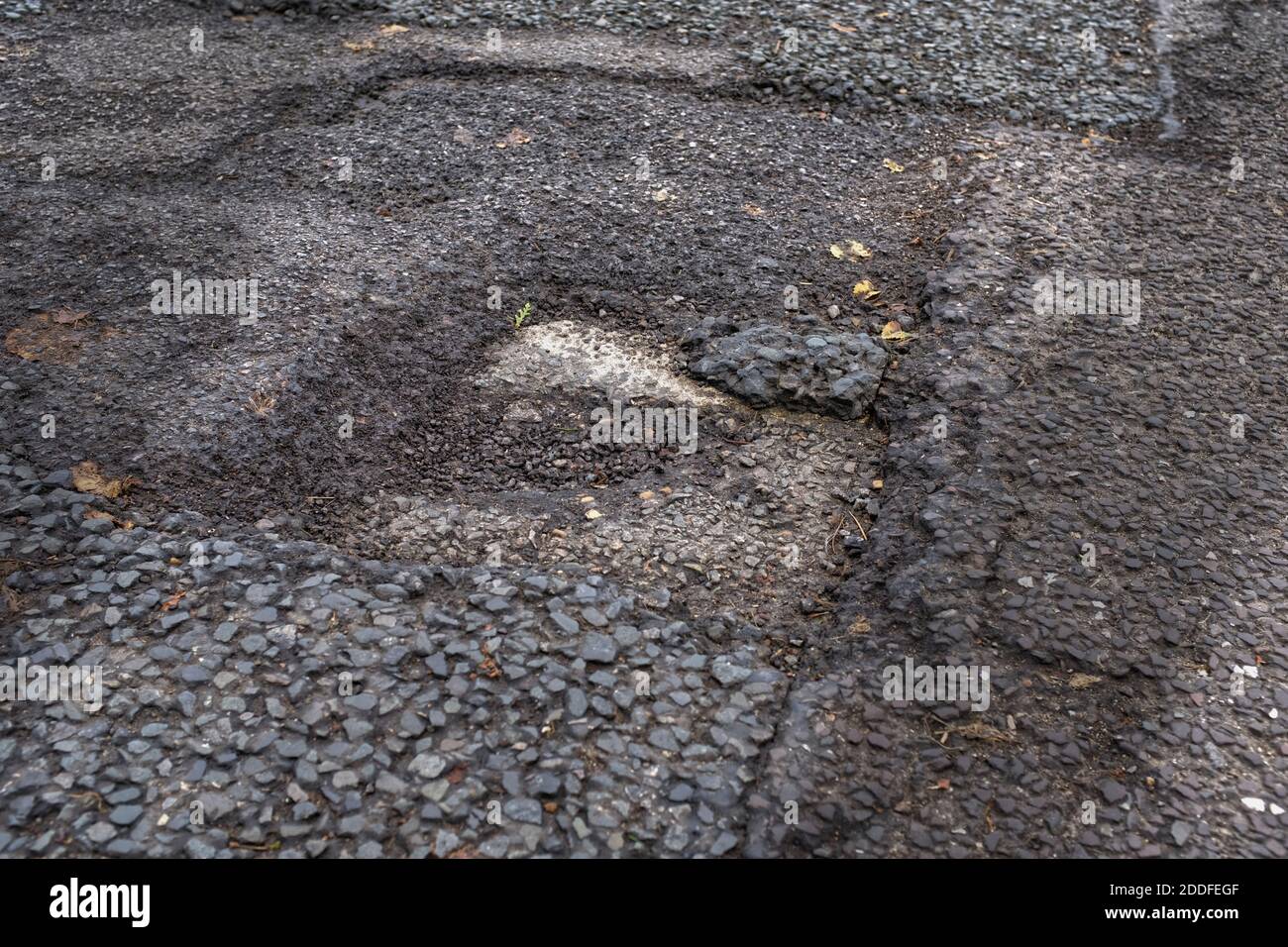 Holes in the un repaired road England Stock Photo Alamy